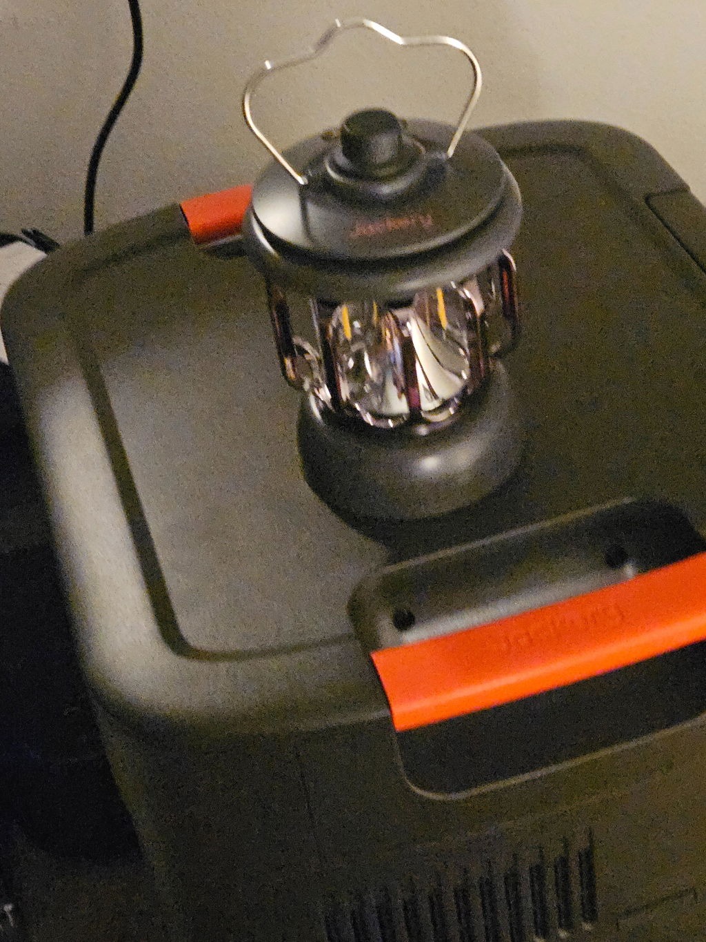 Camping lantern resting on top of an owner's Jackery HomePower 3600 Plus
