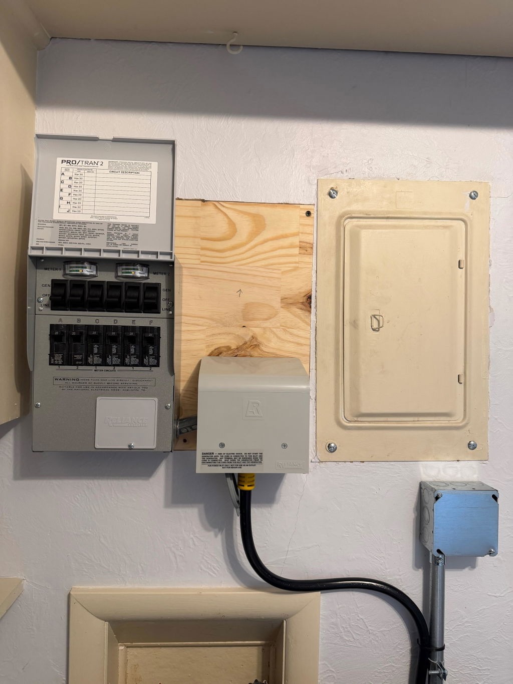 Manual transfer switch installed next to a home breaker panel for a Jackery HomePower 3600 Pro Max